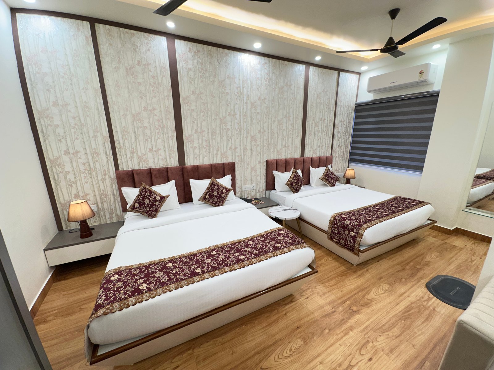 The Premium King Garden View Room at The Ummed Ahmedabad featuring a spacious interior with warm lighting and a king size bed facing the TV mounted on the wall